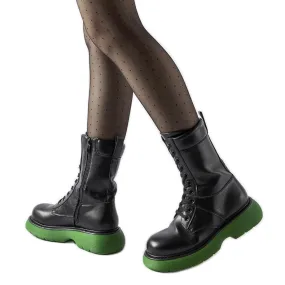 Black insulated boots with a green Beata sole