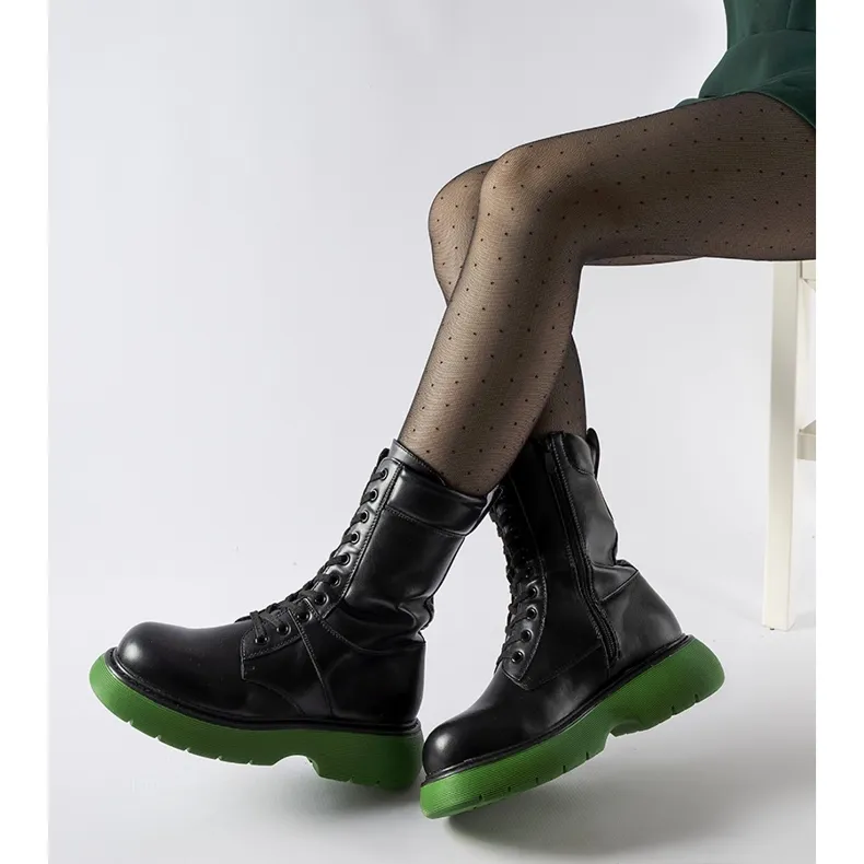 Black insulated boots with a green Beata sole